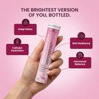 Hand holding a Ayu Daily Gluta Glow with benefits listed on a pink background